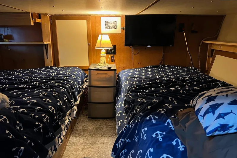 Slide: The Image of Cozy 1989 Holiday Mansion Super interior with twin beds, nautical bedding, and ambient lighting. - 7