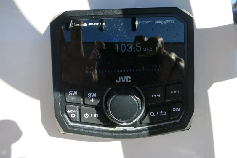 Slide: The Image of JVC radio display on 2019 Sea Born LX22 Center Console, showing FM 103.5 MHz. - 11