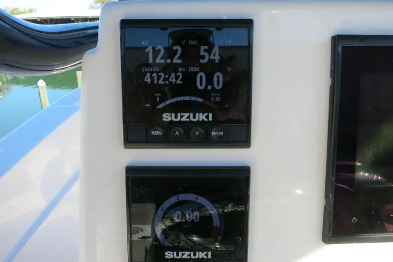 Slide: The Image of Suzuki engine display on 2019 Sea Born LX22 Center Console boat dashboard. - 12