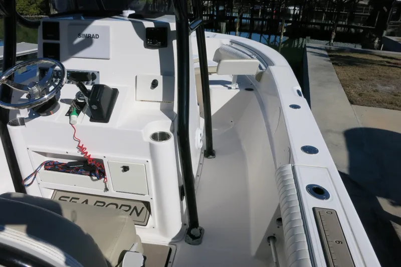 Slide: The Image of 2019 Sea Born LX22 Center Console boat interior with steering wheel and seating. - 13