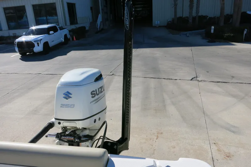 Slide: The Image of 2019 Sea Born LX22 Center Console with Suzuki 250 outboard motor in a parking area. - 22