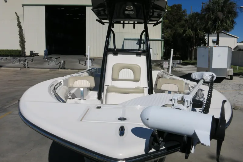 Slide: The Image of 2019 Sea Born LX22 Center Console boat with seating and trolling motor, parked outdoors. - 28