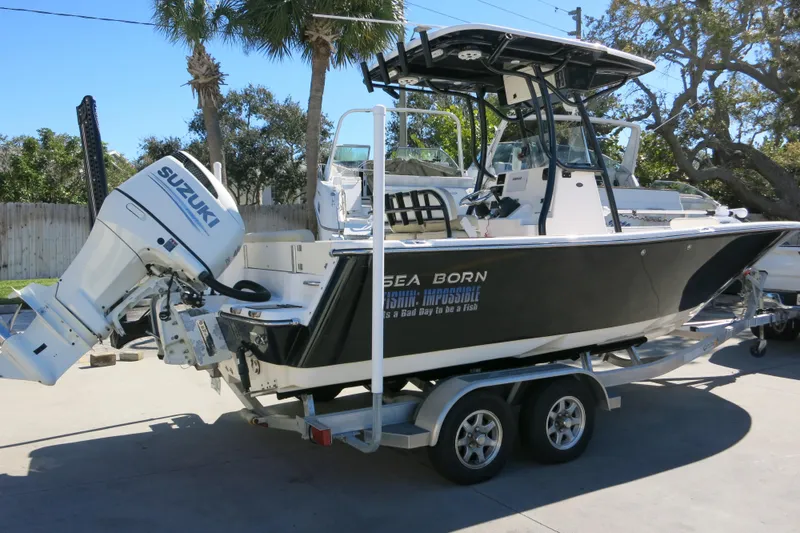 Slide: The Image of 2019 Sea Born LX22 Center Console boat on trailer with Suzuki outboard motor. - 30