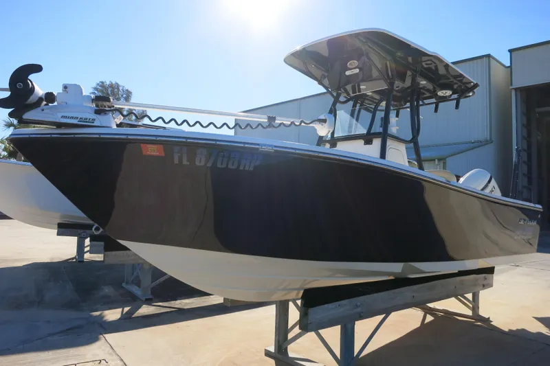 Slide: The Image of 2019 Sea Born LX22 Center Console boat on display in a sunny outdoor setting. - 4
