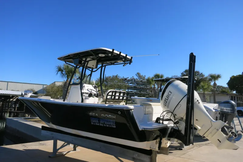 Slide: The Image of 2019 Sea Born LX22 Center Console boat with Suzuki outboard motor on a sunny day. - 6