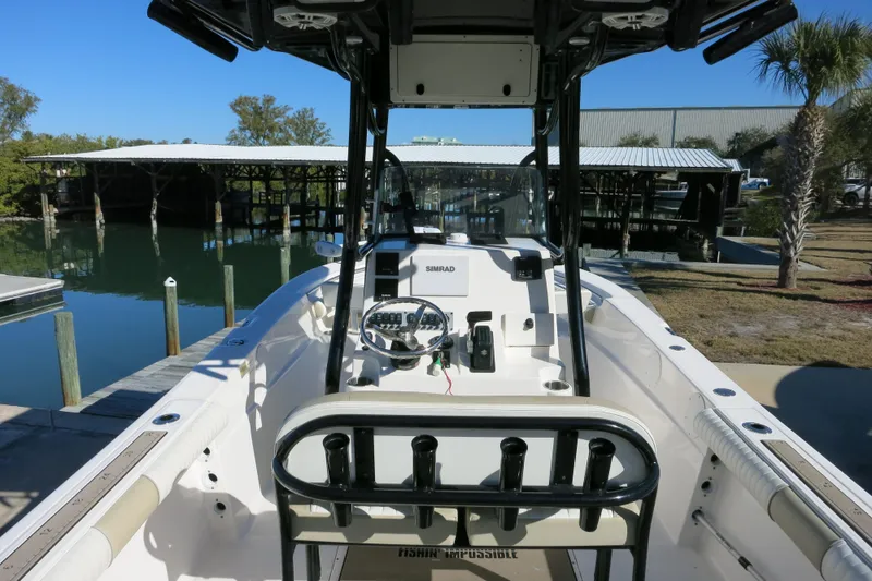 Slide: The Image of 2019 Sea Born LX22 Center Console boat docked at marina, featuring steering console. - 8