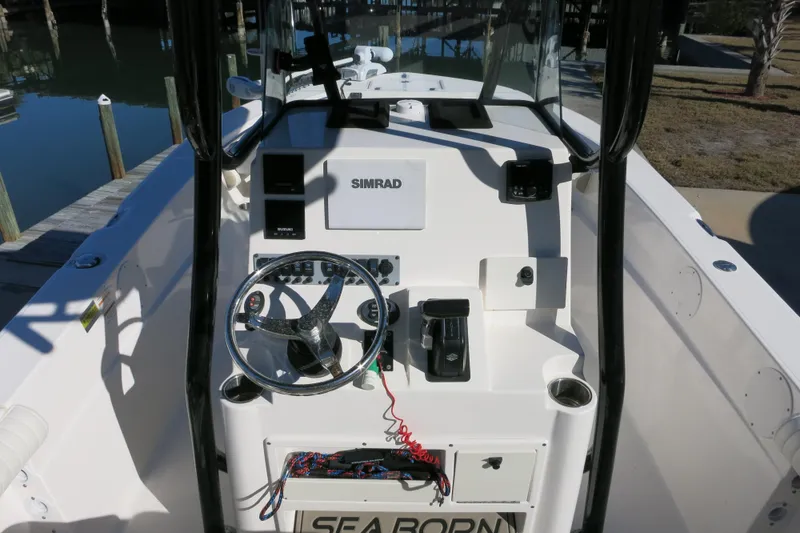 Slide: The Image of 2019 Sea Born LX22 Center Console boat dashboard with steering wheel and controls. - 9