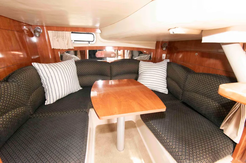 Slide: The Image of Luxurious 2007 Four Winns 358 Vista cabin interior with cozy seating and wooden table. - 11