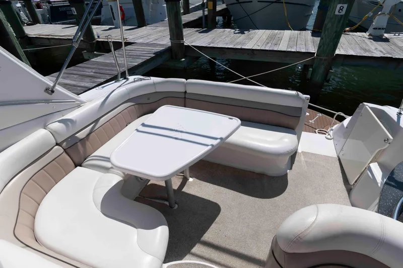 Slide: The Image of 2007 Four Winns 358 Vista boat interior with cushioned seating and table at dock. - 6