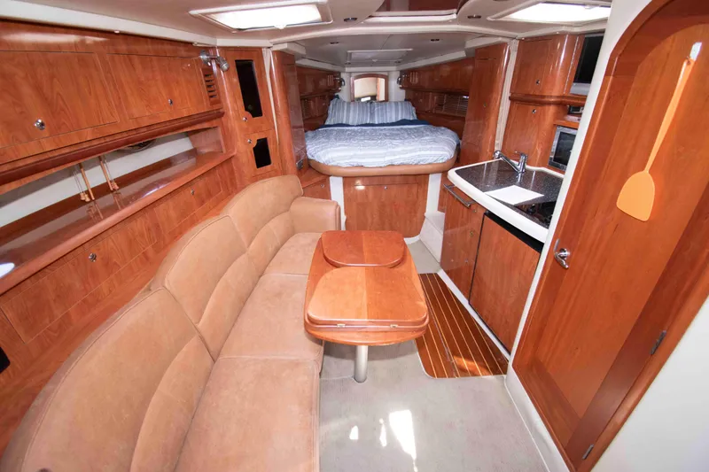 Slide: The Image of Luxurious 2007 Four Winns 358 Vista yacht interior with wood finish and cozy seating area. - 7