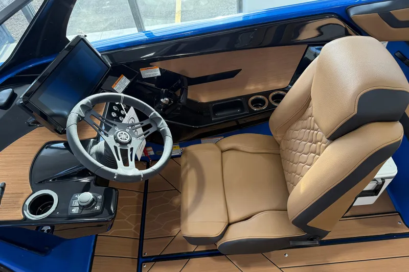 Slide: The Image of 2025 Yamaha Boats 222XE cockpit with modern steering, touchscreen, and tan seating. - 7