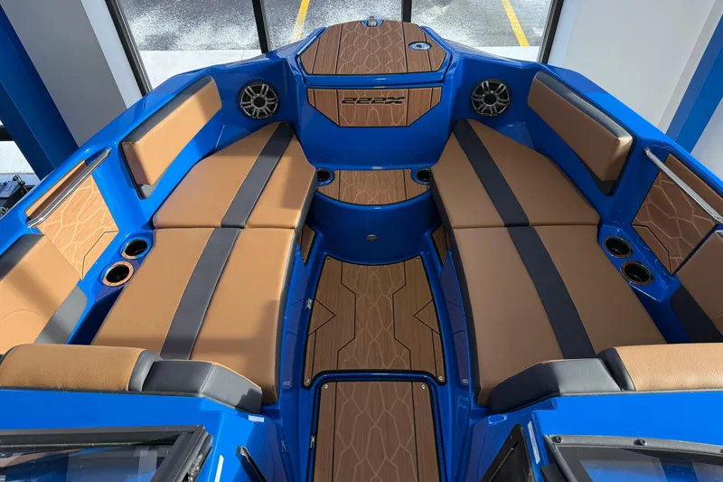 Slide: The Image of 2025 Yamaha Boats 222XE interior with blue and tan seating, modern design. - 9
