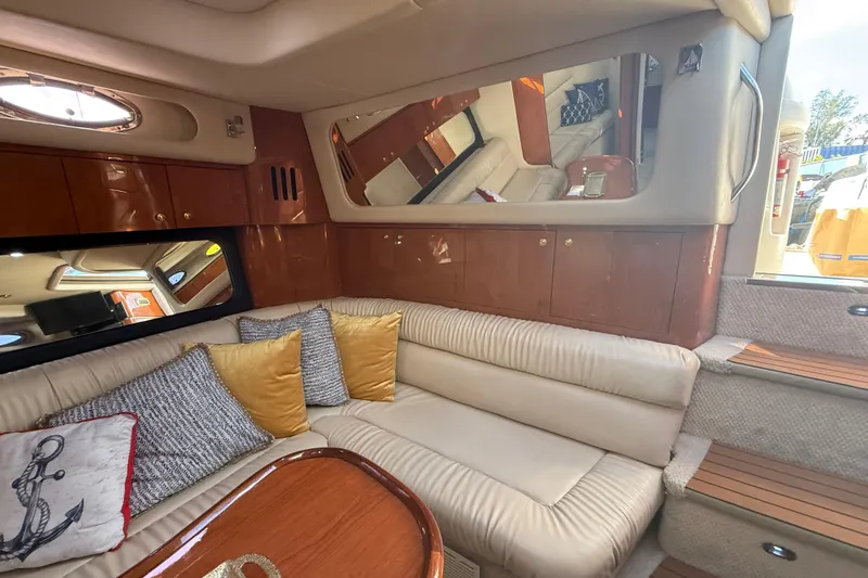Slide: The Image of Luxurious interior of a 1999 Sea Ray 410 Express Cruiser with plush seating and elegant decor. - 15