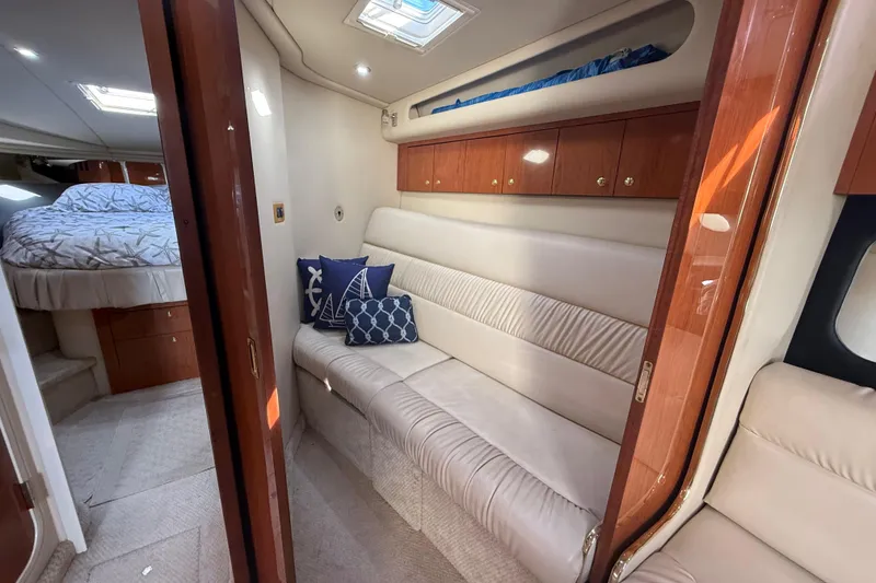 Slide: The Image of Luxurious interior of 1999 Sea Ray 410 Express Cruiser with cozy seating and elegant wood finishes. - 17
