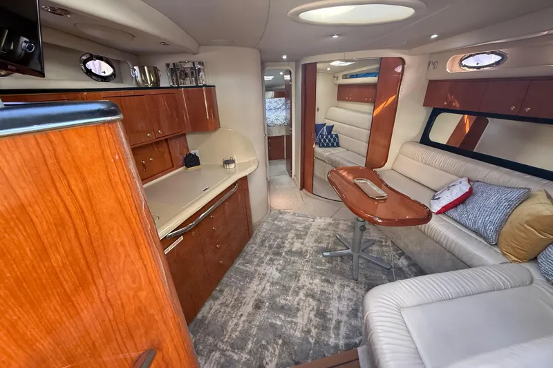 Slide: The Image of Luxurious interior of a 1999 Sea Ray 410 Express Cruiser with elegant wood finishes. - 18