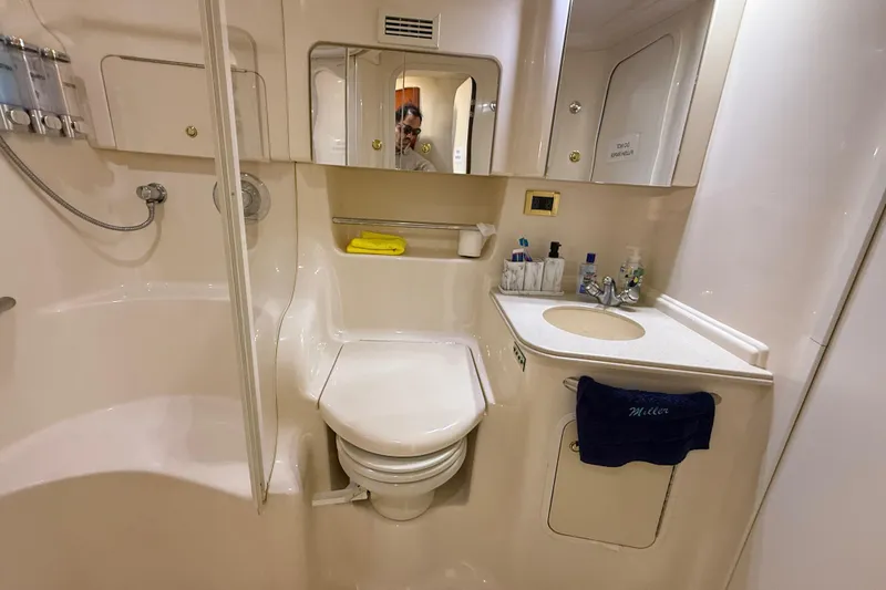Slide: The Image of Bathroom interior of 1999 Sea Ray 410 Express Cruiser with shower and vanity. - 21