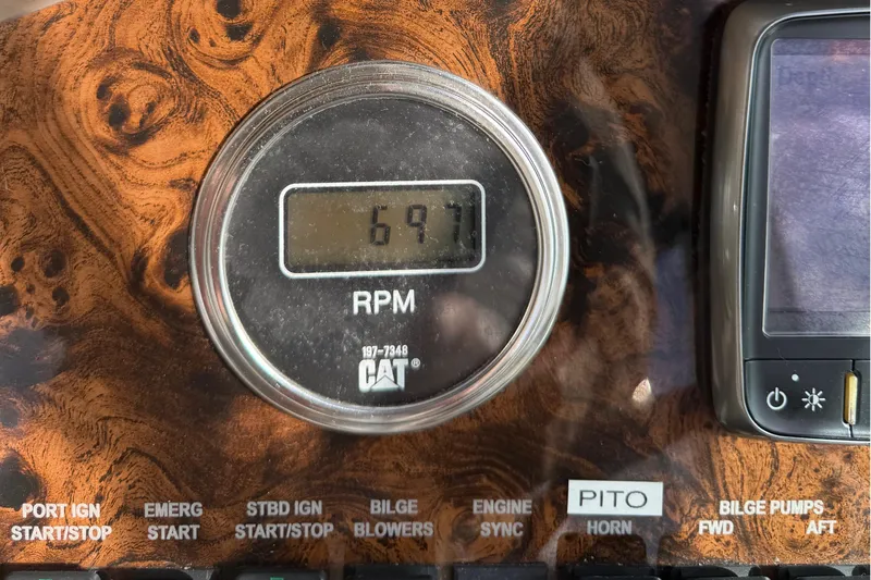 Slide: The Image of RPM gauge on 1999 Sea Ray 410 Express Cruiser dashboard, showing 697 RPM. - 22