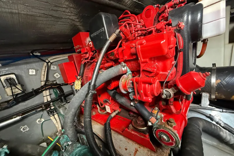 Slide: The Image of Engine compartment of a 1999 Sea Ray 410 Express Cruiser with red engine components. - 25