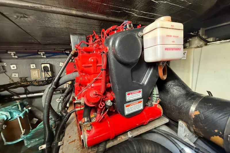 Slide: The Image of Engine compartment of 1999 Sea Ray 410 Express Cruiser with Westerbeke generator. - 26