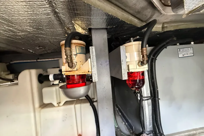 Slide: The Image of Engine room of 1999 Sea Ray 410 Express Cruiser with fuel filters and hoses. - 27