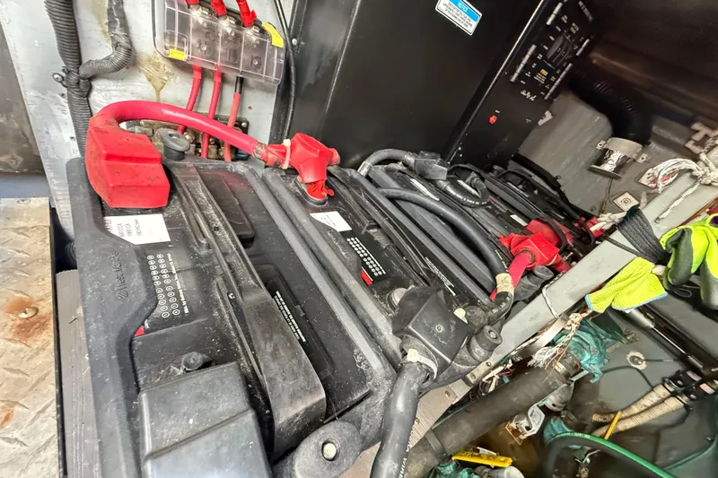 Slide: The Image of Battery compartment of a 1999 Sea Ray 410 Express Cruiser with cables and connections. - 29
