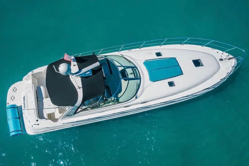 Slide: The Image of 1999 Sea Ray 410 Express Cruiser on turquoise water, aerial view. - 3