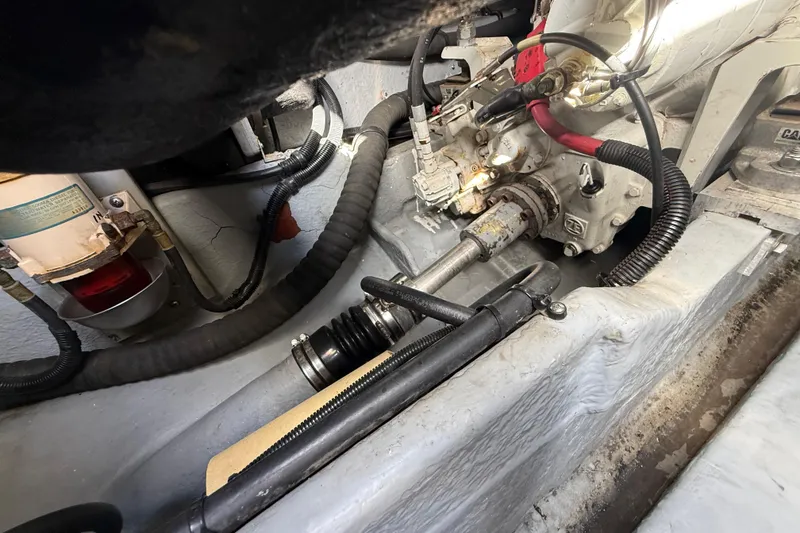 Slide: The Image of Engine compartment of a 1999 Sea Ray 410 Express Cruiser, showing mechanical components and wiring. - 31