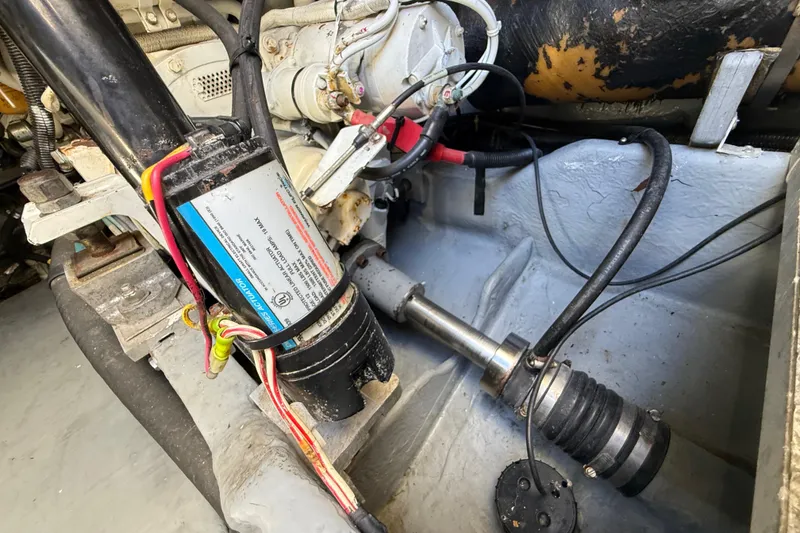 Slide: The Image of Engine compartment of a 1999 Sea Ray 410 Express Cruiser, showing mechanical components and wiring. - 32