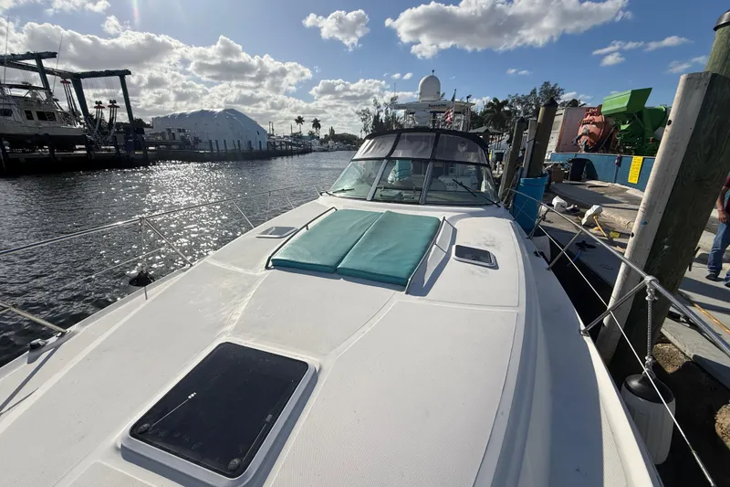 Slide: The Image of 1999 Sea Ray 410 Express Cruiser docked at marina under sunny skies. - 5