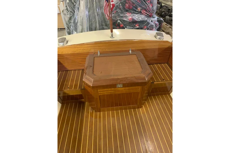 Slide: The Image of 1973 Lyman Islander boat interior with polished wooden deck and American flag. - 16