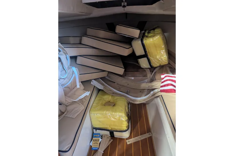 Slide: The Image of Interior of a 1973 Lyman Islander boat with cushions and life jackets. - 18