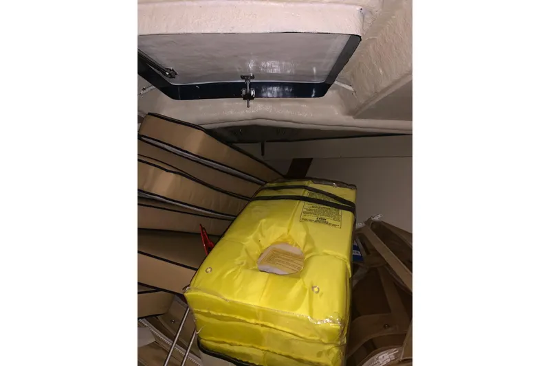 Slide: The Image of Interior of a 1973 Lyman Islander boat with yellow life jacket and cushions. - 21