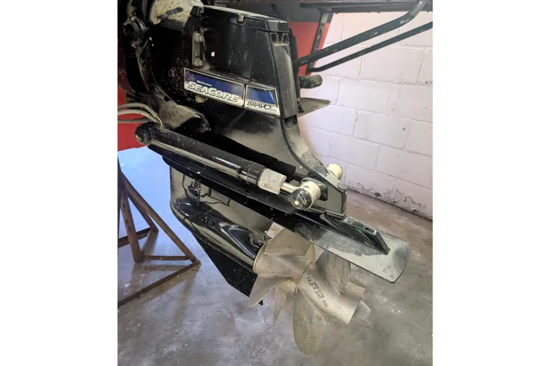 Slide: The Image of 1973 Lyman Islander boat with MerCruiser SEACORE Bravo engine in a garage setting. - 24