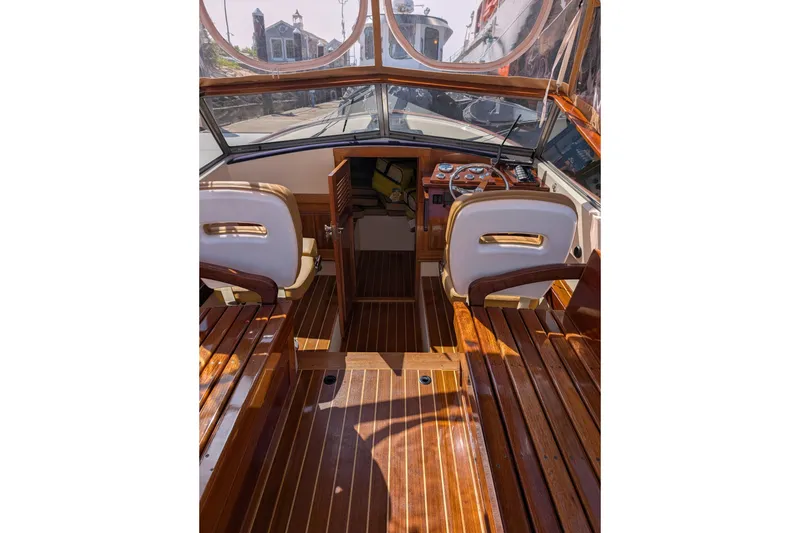 Slide: The Image of 1973 Lyman Islander boat interior with polished wood and steering wheel. - 5