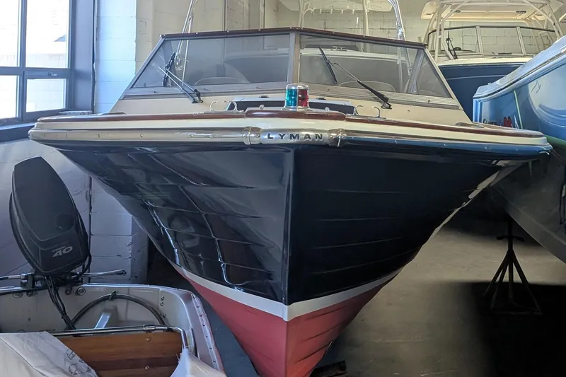 Slide: The Image of 1973 Lyman Islander boat in storage, featuring classic design and sleek lines. - 7