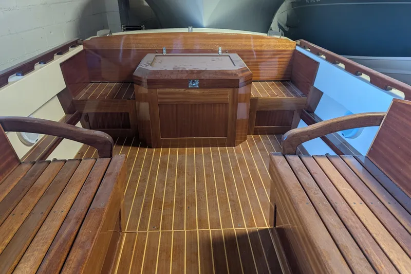 Slide: The Image of 1973 Lyman Islander boat interior with polished wooden seating and flooring. - 8