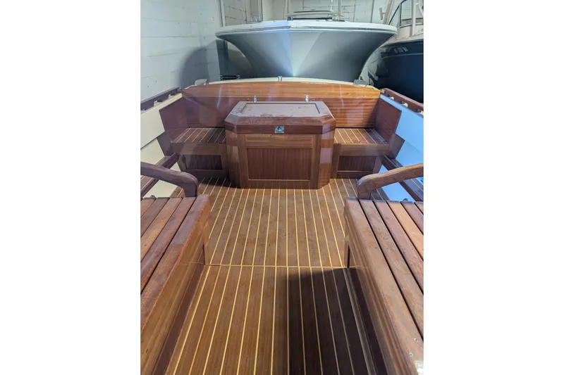 Slide: The Image of 1973 Lyman Islander boat interior with wooden seating and flooring. - 9