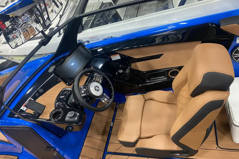 Slide: The Image of 2025 Yamaha Boats 222XD cockpit with tan seating and modern controls. - 3