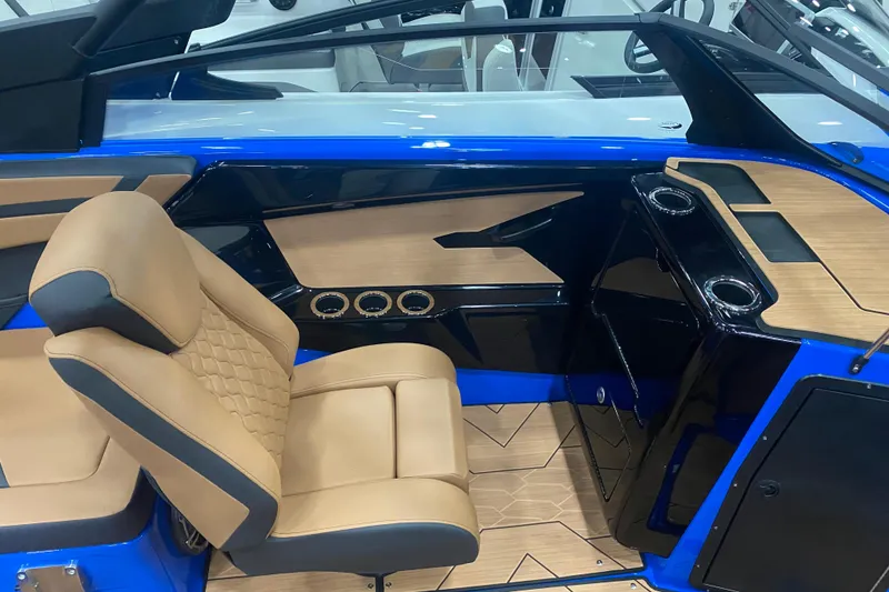 Slide: The Image of 2025 Yamaha Boats 222XD interior with tan seating and sleek black accents. - 5