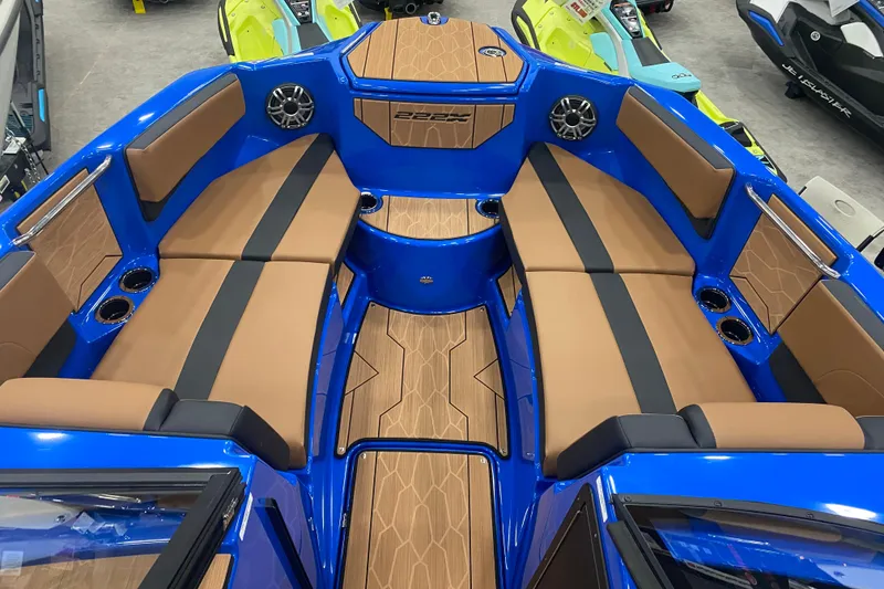 Slide: The Image of 2025 Yamaha Boats 222XD interior with blue and tan seating, modern design, and cup holders. - 6