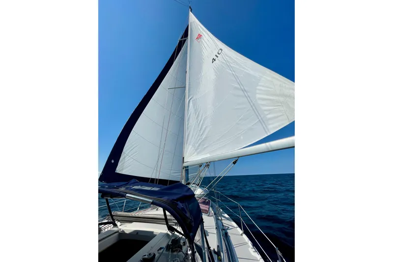 Slide: The Image of Sailing on a 2004 Catalina 350 yacht with white sails against a clear blue sky. - 11