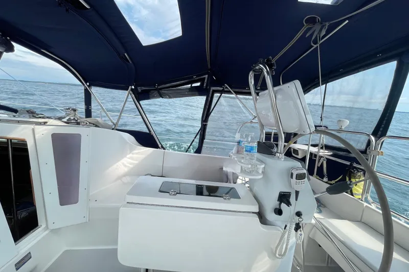 Slide: The Image of Cockpit of 2004 Catalina 350 sailboat with steering wheel and navigation equipment. - 15