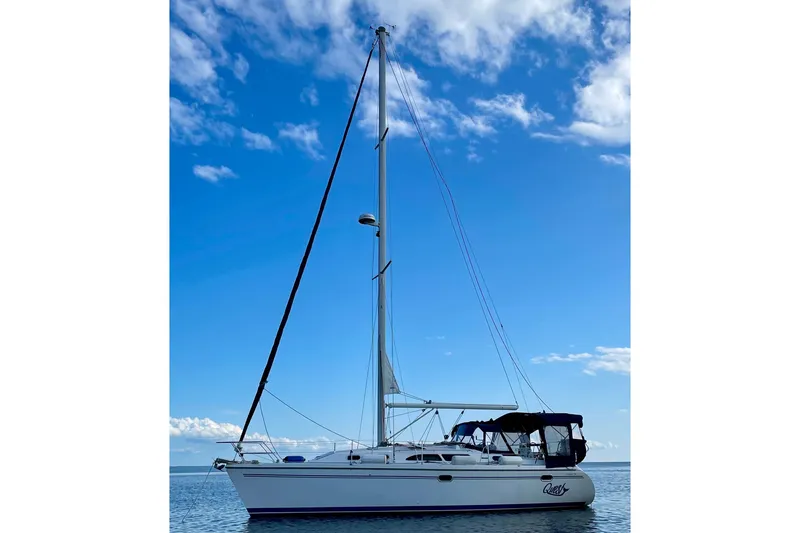 Slide: The Image of 2004 Catalina 350 sailboat on calm water under a clear blue sky. - 2