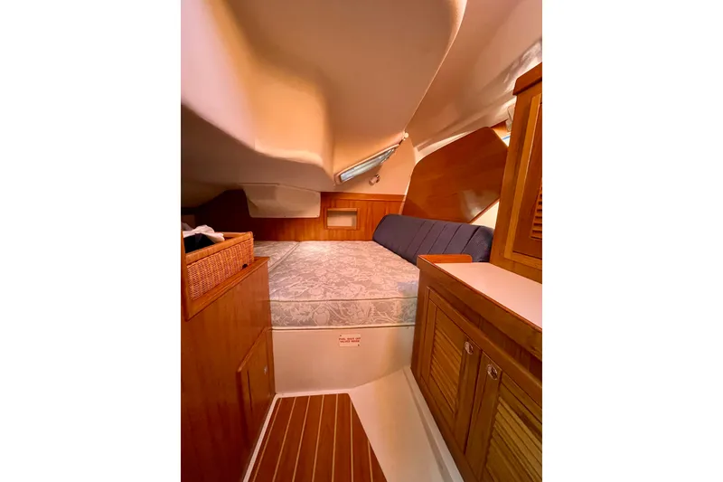 Slide: The Image of Cozy cabin interior of a 2004 Catalina 350 sailboat with wooden furnishings. - 26
