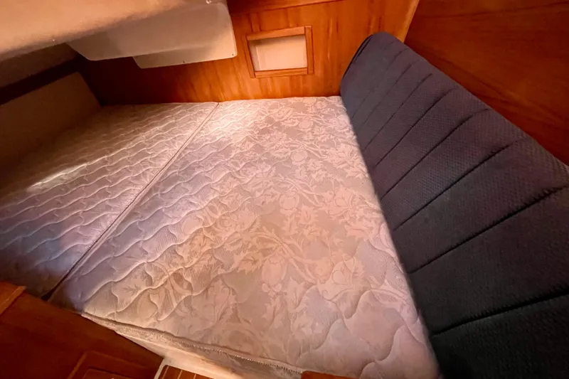 Slide: The Image of Interior cabin of 2004 Catalina 350 sailboat with a comfortable bed setup. - 27