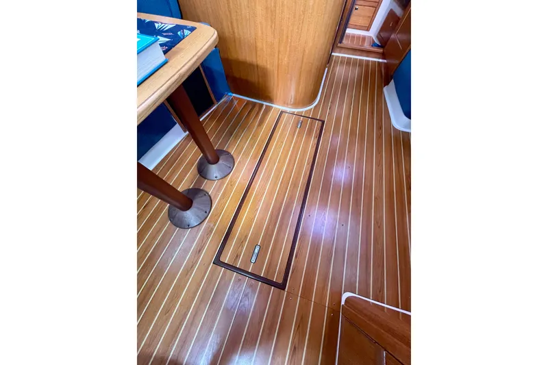 Slide: The Image of Interior of a 2004 Catalina 350 sailboat with polished wooden flooring. - 29