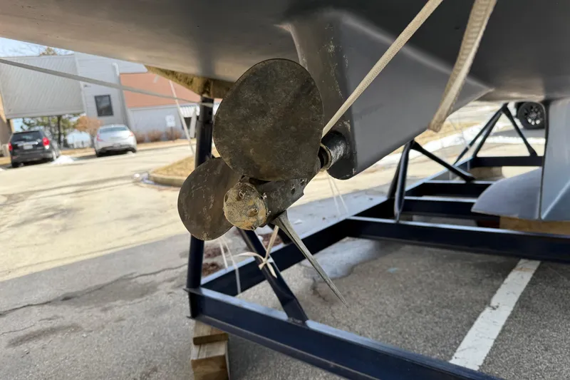 Slide: The Image of Catalina 350 sailboat propeller on trailer, 2004 model, in a parking lot. - 38