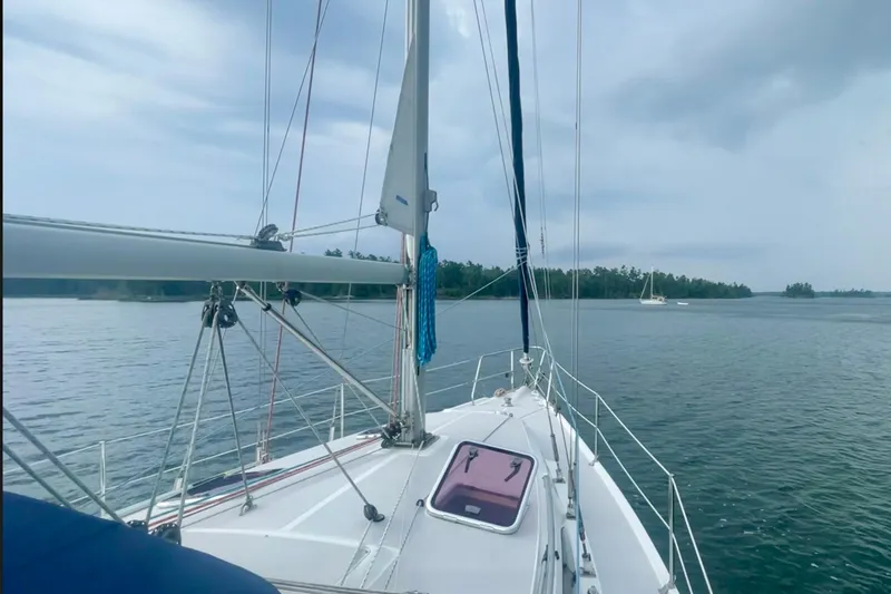 Slide: The Image of Sailing on a 2004 Catalina 350 yacht in calm waters under a cloudy sky. - 7