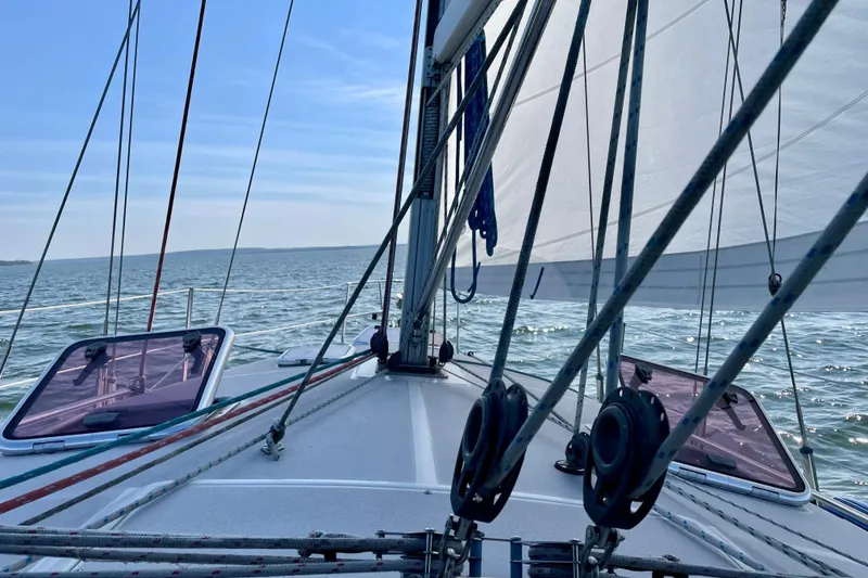 Slide: The Image of Sailing on a 2004 Catalina 350 yacht, open sea view, clear blue sky. - 8