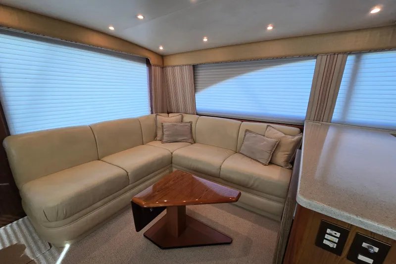 Slide: The Image of Luxurious interior of 2007 Ocean Yachts 46 Super Sport with beige seating and wooden table. - 14